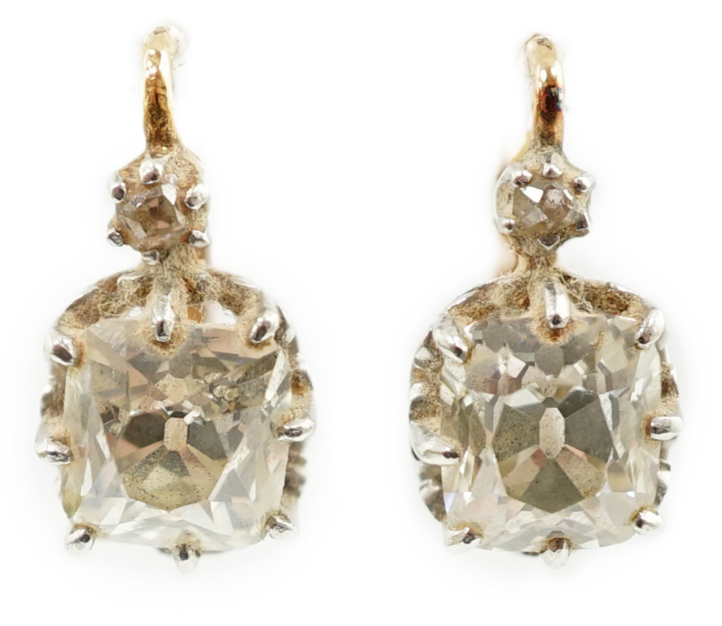 A pair of late 19th/early 20th century gold and two stone cushion cut diamond set earrings